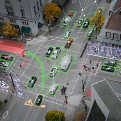 a aerial view of a city street with cars and buildings